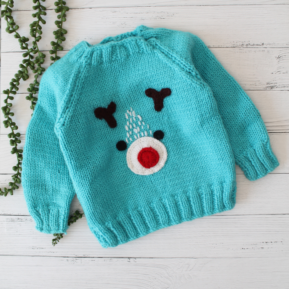 Bright Turquoise Blue Colored With Bear Face Pattern sweater.